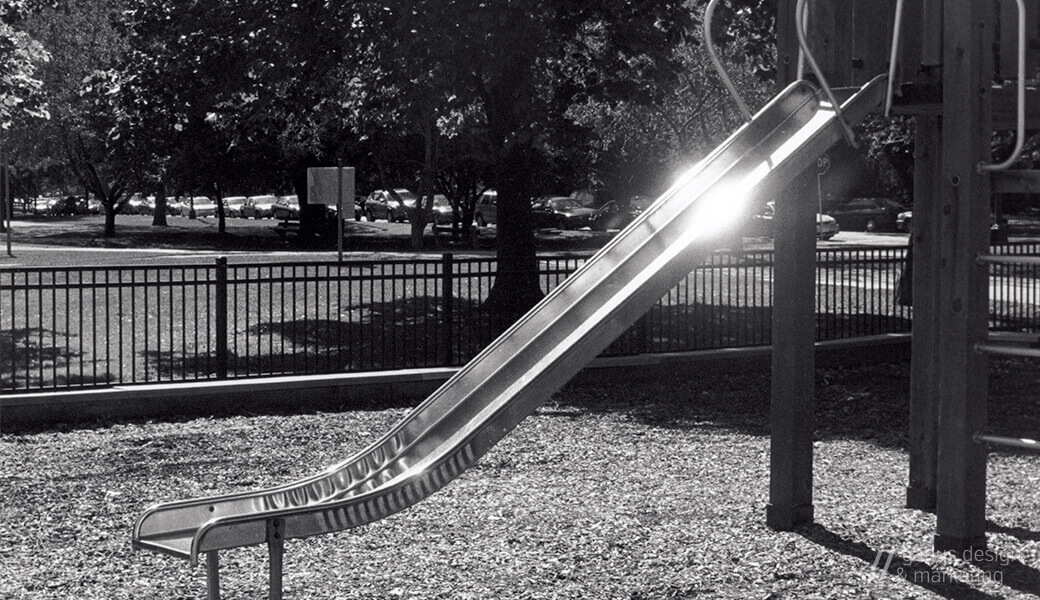 A photograph of the Belmont Park slide in Chicago, during golden hour, 2003.